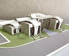 a paper model of a house with trees and bushes