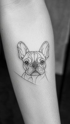 a small black and white dog tattoo on the left leg, with an outline of a bulldog's face