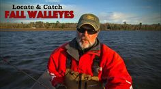 an older man is fishing in the water with his hat on and red jacket over