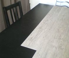 a dining room table with black and white chairs