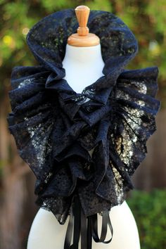 Add a little fantasy to your wardrobe with an avant garde ruffled fashion collar, in black vintage-inspired floral lace. It's gorgeous and mysterious over bare shoulders for evening, perfectly enchanting for a Victorian wedding, or a wonderful addition to a burlesque wardrobe. Makes a lovely neck ruff for an Elizabethan costume too. Double drawstring ties make it easy for you to create your own look with it on a whim. Wear it 5 different ways: *Wear it long and loose. *Tie the two ends together Black Lace Fashion, Steampunk Mode, Elizabethan Costume, Moda Steampunk, Couture Dior, Gothic Mode, Victorian Collar, Mode Steampunk, Ruff Collar