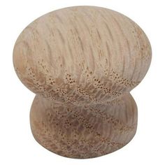 a wooden knob with holes in the middle on a white background, it is made out of wood