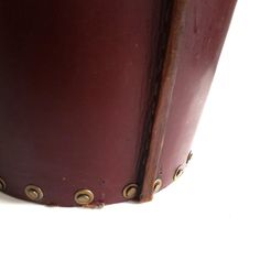 a close up of a brown leather case with rivets on the bottom and sides