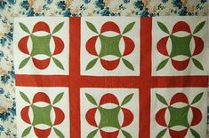 a red and green quilted with flowers on it's sides, in the center