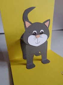 a card with a cat cut out of it's face on a yellow background