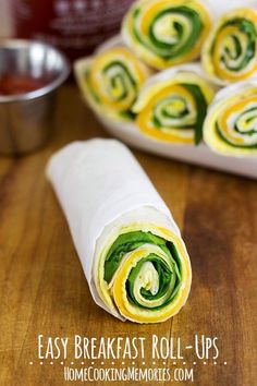 rolled up food item sitting on top of a wooden table