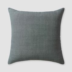 the grey linen pillow is shown on a white background