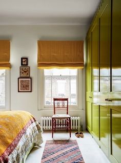 a bedroom with green cabinets and a yellow bed