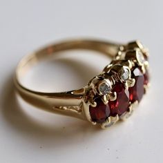 A ring of diamonds totaling 0.25 carats and deep-red garnets, to be cherished in your family for generations to come. Ring size ranges from 4-8. Red Garnet Jewelry, Russian Ring, Jewelry Knowledge, Garnet And Diamond Ring, Garnet Jewelry, Ancient Jewelry, Vintage Jewels, Red Stone, Hand Made Jewelry