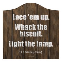 a red poster with white text that reads, lace'em up whack the biscuit light the lamp it's a hockey thing