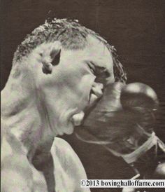 an old photo of a man with his mouth open and boxing gloves hanging out to him