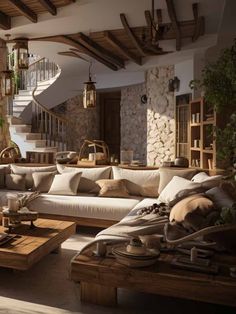 a living room filled with lots of furniture next to a stone wall covered in plants