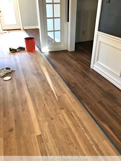 an empty room with hard wood floors and white trim