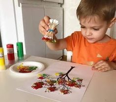 a little boy that is sitting at a table