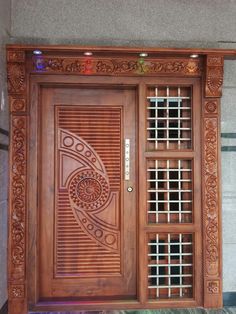 an ornate wooden door with glass inserts