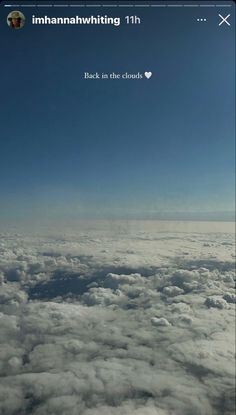 the view from an airplane looking down on clouds and blue sky with words written below