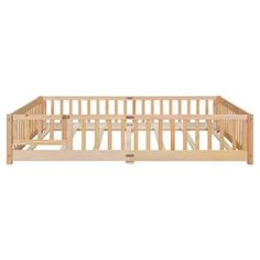 a wooden baby crib with no mattress on the bottom and side rails, in front of a white background