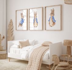 a bedroom with white walls and pictures on the wall