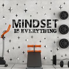 an exercise room with black and white stars on the wall that says mindset is everything