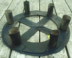 a circle made out of metal pipes sitting on top of a wooden table