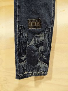 Customized Denim Jeans ( B.I.G Brooklynn Tribute) - Triple Applique Patchwork - Laser Engraving Finish - Stonewash 100% Cotton Relaxed Fit 33W x 32L Denim Blue Graphic Bottoms For Streetwear, 90s Rigid Denim Jeans For Streetwear, 90s Style Rigid Denim Jeans For Streetwear, Urban Fitted Jeans For Streetwear, Fitted Urban Jeans For Streetwear, Urban Style Jeans For Streetwear, Dark Wash Recycled Denim Jeans For Streetwear, Urban Jeans With Graphic Print In Denim Blue, Urban Style Graphic Print Denim Jeans