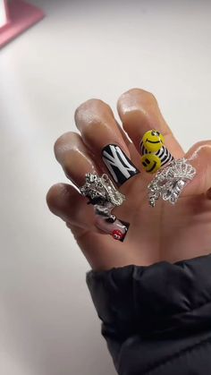 a person holding up their hand with some nail art on it's palm and fingers