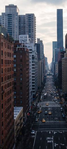 an aerial view of a city street with tall buildings