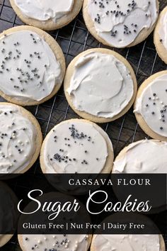 sugar cookies with white frosting and sprinkles are on a cooling rack