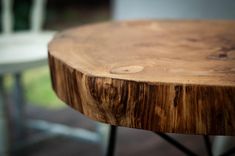 a wooden table sitting on top of a hard wood floor next to a white chair