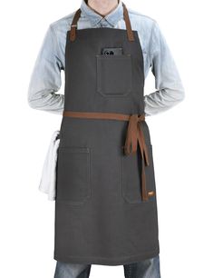 a man wearing an apron with his hands on his hips