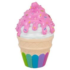 an ice cream cone with pink frosting and sprinkles on it's top