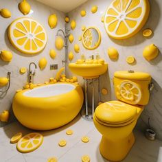 a bathroom decorated in yellow and white with lemon slices on the wall