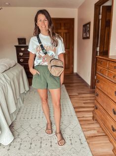 green linen shorts outfit, graphic tee with bright flowers, tan Baggu belt bag fashion, brown leather thin strap Tevas style, gold jewelry outfit ideas, casual summer outfit, linen shorts and graphic tee look, tan belt bag style, trendy casual fashion, floral graphic tee outfit, summer casual outfit ideas, green shorts fashion, graphic tee and shorts style, Tevas sandals outfit, gold accessories fashion, casual gold jewelry ideas, summer chic fashion, trendy summer look, stylish casual outfit, floral graphic tee fashion, green linen shorts style, tan Baggu bag look, brown Tevas sandals outfit, summer casual fashion tips, stylish casual jewelry, floral graphic tee ideas, gold jewelry fashion inspiration, casual summer chic outfit Tee Shirt And Shorts Outfit, Brown Teva Sandals Outfit, Tan Linen Shorts Outfit Summer, Tevas Outfit Summer, Tan Linen Shorts Outfit, Summer Graphic Tee In Khaki, Olive Green Shorts Outfit Summer, Shorts And Graphic Tee, White Graphic Tee Outfit