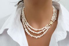 This is a gorgeous handmade necklace made with baroque freshwater pearls. It is a unique piece due to the irregular-shaped pearls, which add a natural touch to the necklace. The necklace is a beautiful gift to yourself or others! These pearls can fit with any outfit, ranging from casual to formal. Pearls should be a part of everybody's collection.  The baroque pearls are approximately 4-6mm. The box clasp is 24K Gold Plated. **Model is wearing a 15" necklace** **Do not use liquid chemicals on the beads, just use a polishing cloth** Our items are shipped in a nice mesh pouch in a gift box. All jewelry needs to be returned unworn and in its original condition and packaging.  Earrings are NOT returnable for hygiene reasons. We hold the right to deny a return if the product you have sent back Three Strand Pearl Necklace, 15 Necklace, Beautiful Pearl Necklace, Clasp Necklace, Box Clasp, Freshwater Pearl Necklace, Necklace Box, Wedding Jewellery Necklace, Freshwater Pearl Necklaces