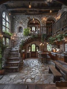 an old stone building with stairs and tables in the center, surrounded by greenery