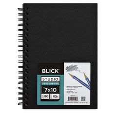 a black notebook with two pencils in it and the cover is blank for text