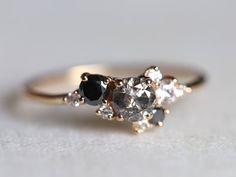 an engagement ring with black and white stones