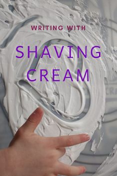 a hand touching the top of a white cream container with text reading writing with shaving cream