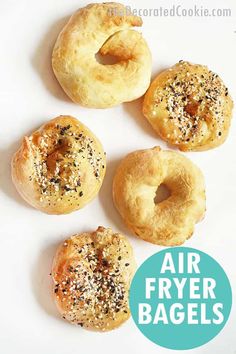 four air fryer bagels on a white surface with the words air fryer bagels above them