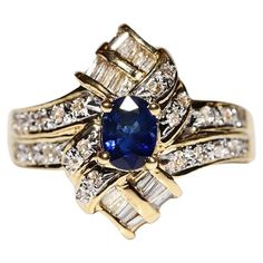 an image of a blue and white ring with diamonds on the sides, set in gold