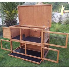 an open wooden box sitting on top of grass