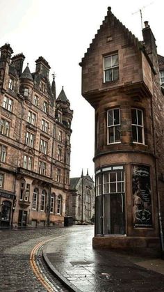 an old building on the corner of a cobblestone street in edinburgh, scotland