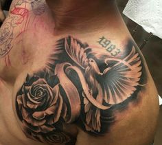 a man with a rose and dove tattoo on his chest