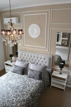 a bedroom with a chandelier hanging from the ceiling