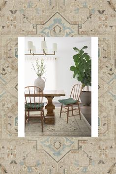 a table with two chairs and a potted plant