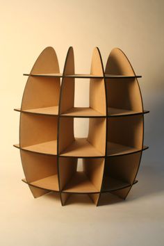 a book shelf made out of cardboard with curved shelves on each side and two circular sections at the top