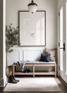 a white room with a bench, plant and pictures on the wall in front of it