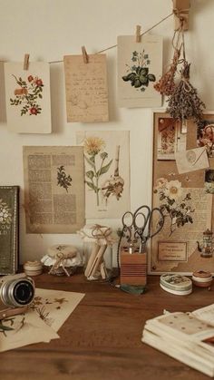 a wooden desk topped with lots of papers and pictures