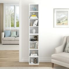 a living room filled with furniture and a white book shelf in front of a window