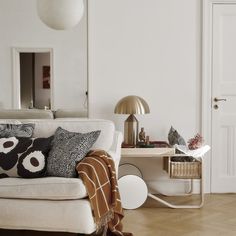 a living room with white walls and wooden floors